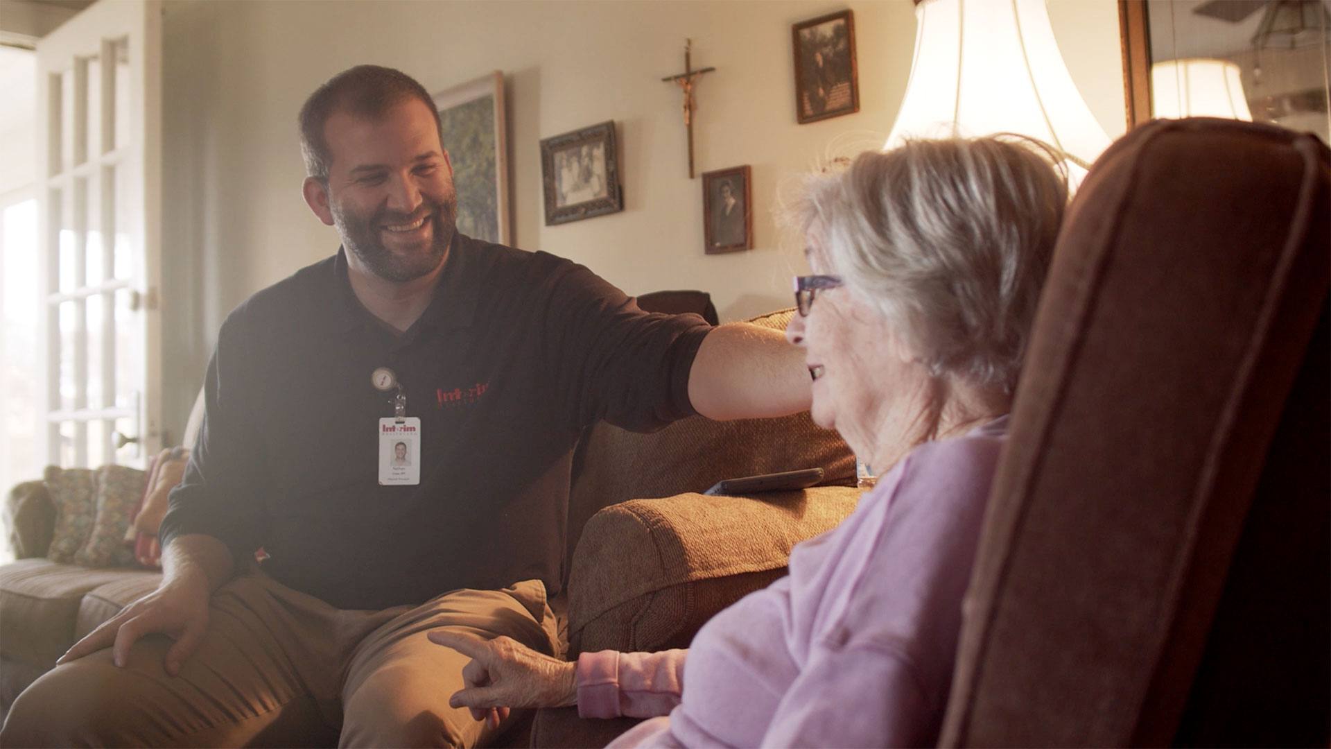 Image of Interim Healthcare working talking with elderly client