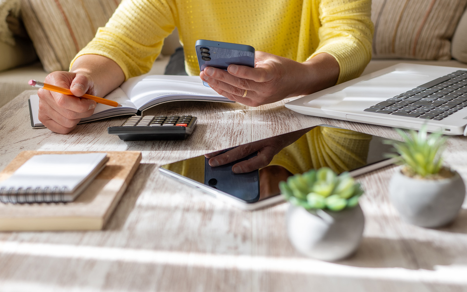 An individual works on personal finances at home