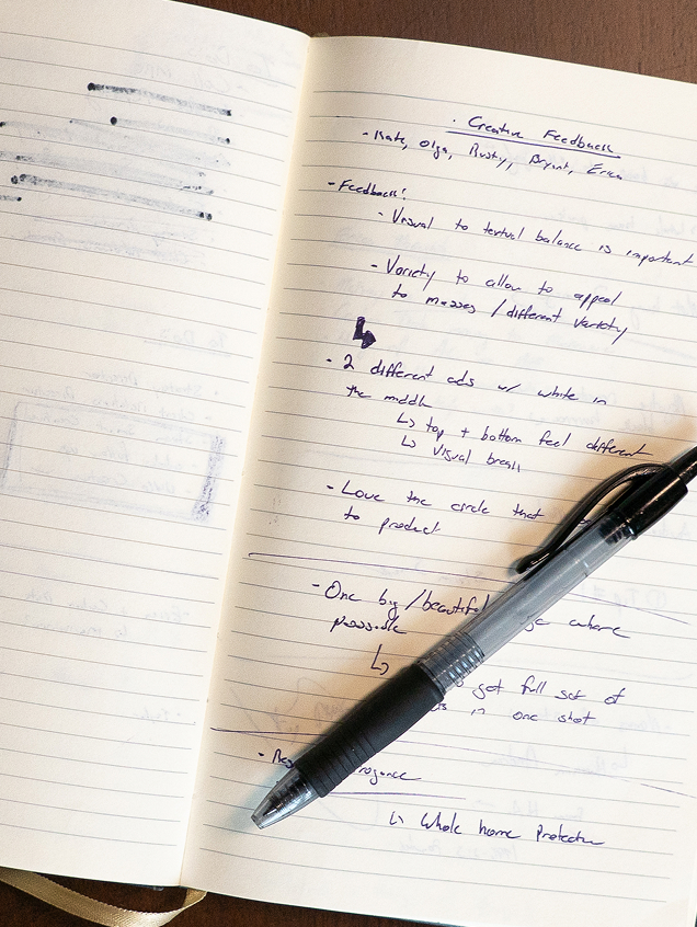 Open notebook with handwritten notes and pen